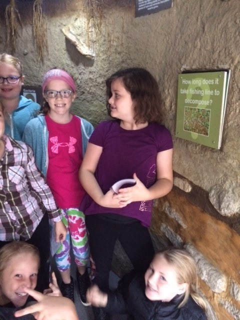 kids next to cave wall